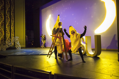 Men dressed in banana suits on stage