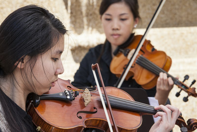Two girls playing their violins