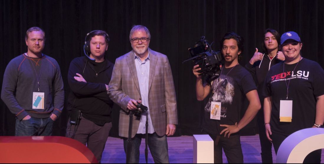 the video production crew on stage with their equipment
